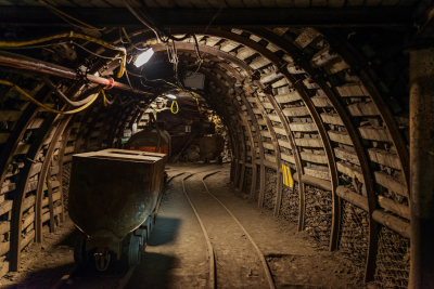 Underground train in black coal mine tunnel